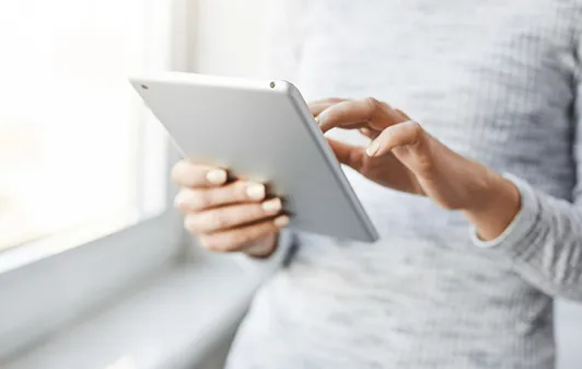 Person reading articles on a tablet